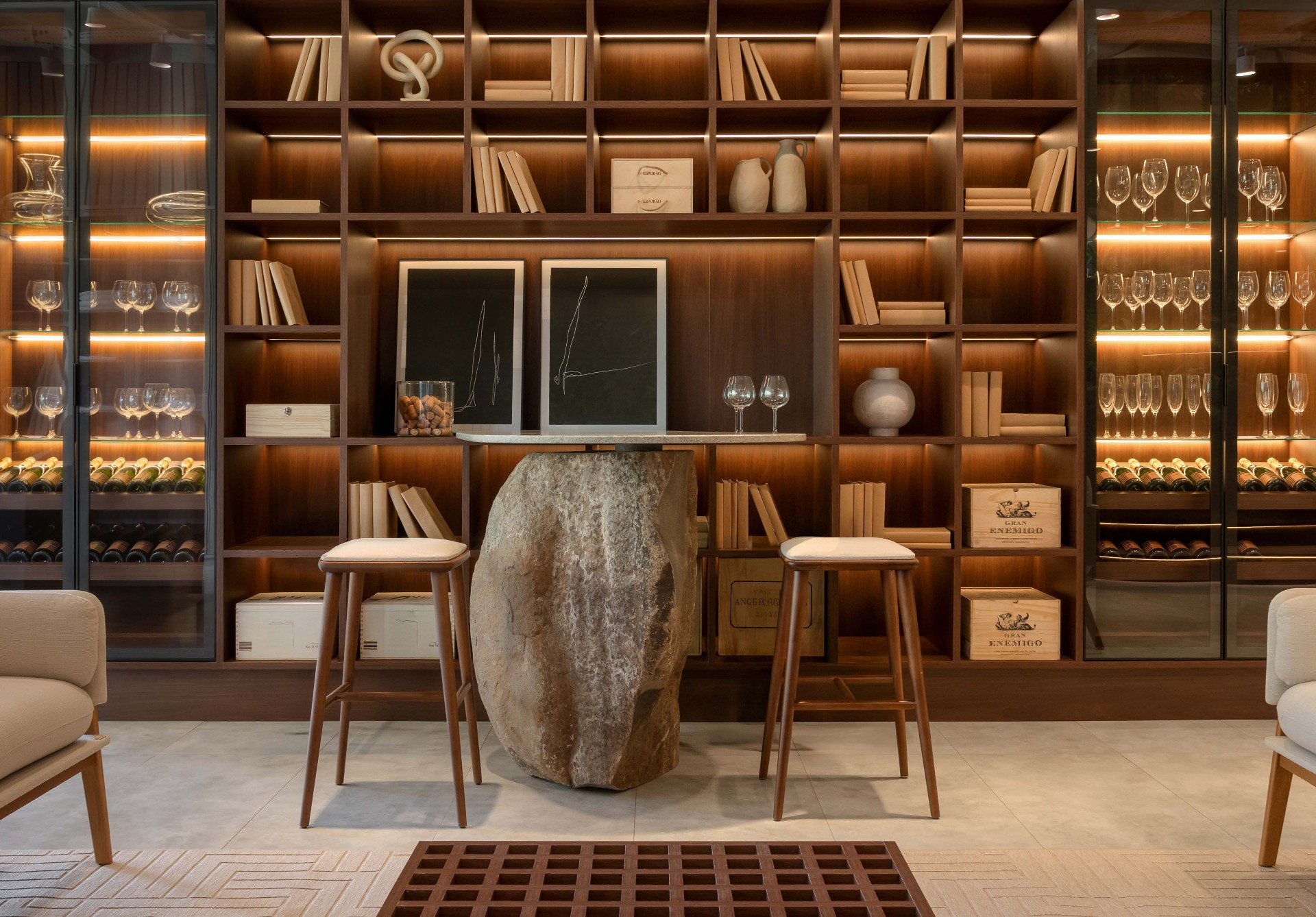 Adega con biblioteca de madera y vinoteca iluminada